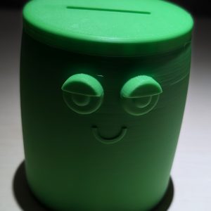 Runde Spardose in grün mit Gesicht